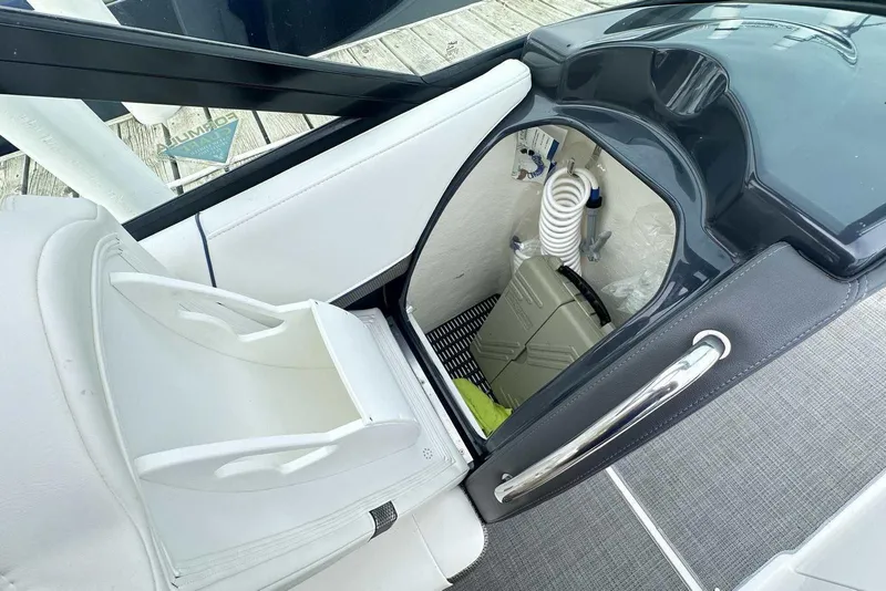 Slide: The Image of 2022 Formula 350 Crossover Bowrider I/O interior storage compartment with white seating. - 11