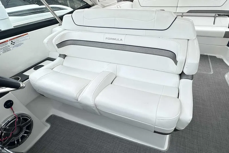 Slide: The Image of 2022 Formula 350 Crossover Bowrider I/O interior with white leather seating and speaker system. - 12
