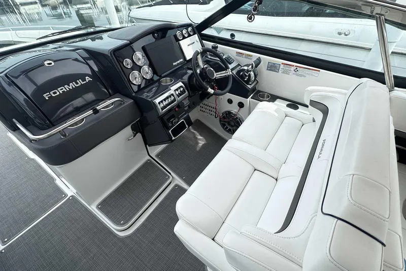 Slide: The Image of 2022 Formula 350 Crossover Bowrider I/O cockpit with sleek dashboard and luxurious seating. - 14