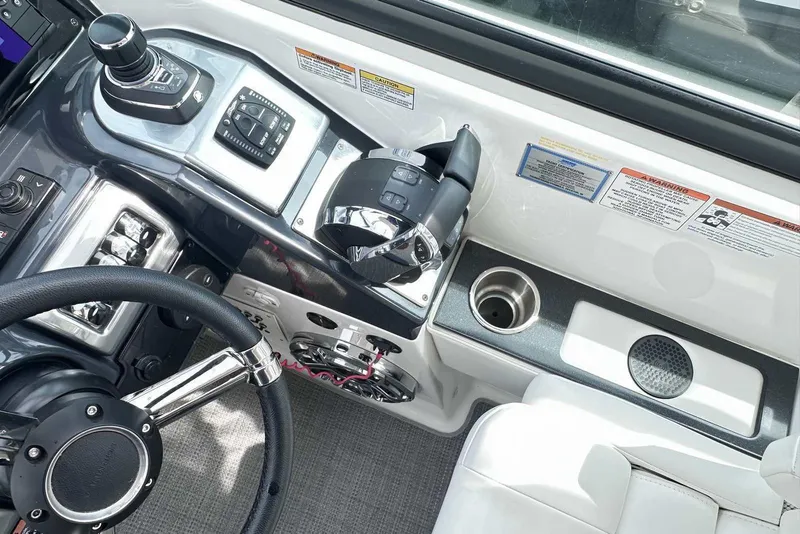 Slide: The Image of 2022 Formula 350 Crossover Bowrider I/O helm with steering wheel and controls. - 16