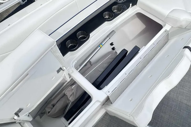 Slide: The Image of 2022 Formula 350 Crossover Bowrider I/O storage compartment with cup holders and accessories. - 23