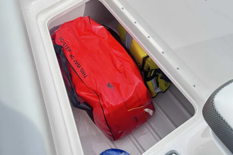 Slide: The Image of Storage compartment in 2022 Formula 350 Crossover Bowrider I/O with red and yellow bags. - 24