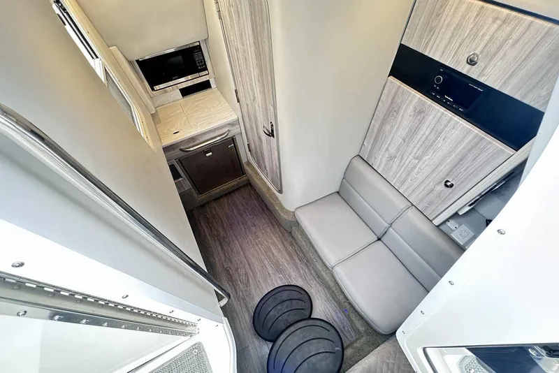 Slide: The Image of 2022 Formula 350 Crossover Bowrider I/O interior with modern seating and kitchenette. - 26