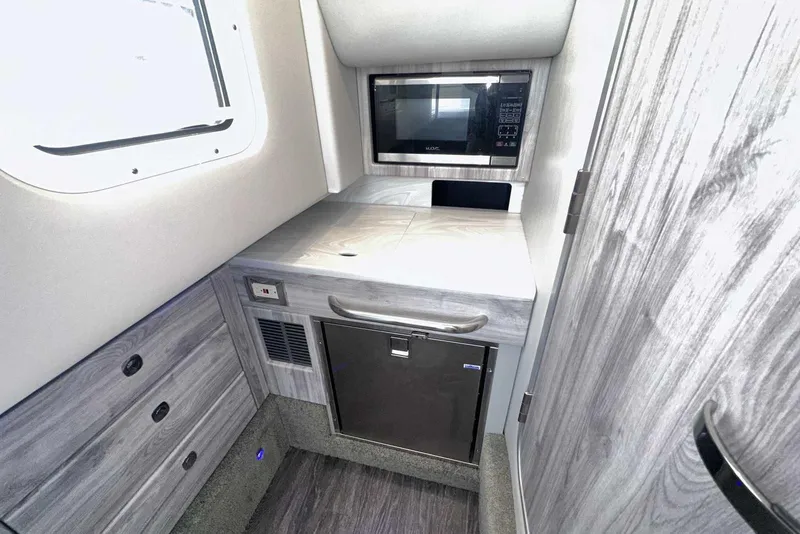 Slide: The Image of 2022 Formula 350 Crossover Bowrider I/O interior with microwave and storage cabinets. - 30
