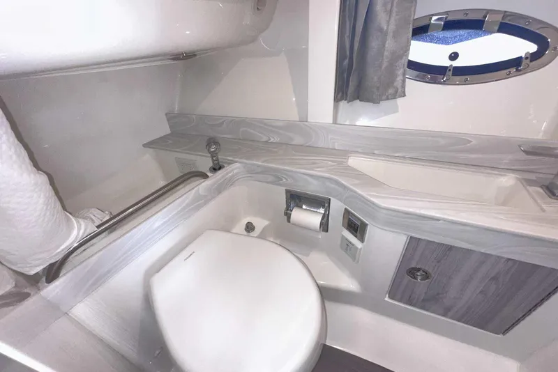 Slide: The Image of 2022 Formula 350 Crossover Bowrider I/O bathroom with modern fixtures and porthole window. - 35