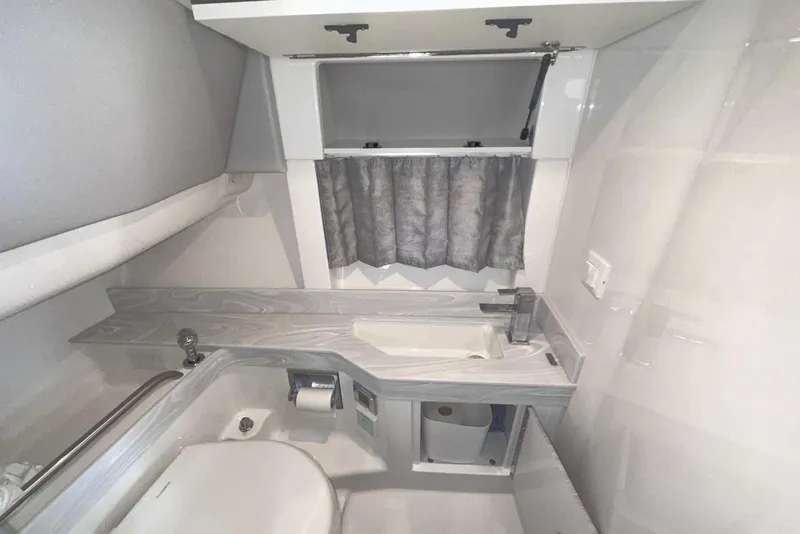 Slide: The Image of 2022 Formula 350 Crossover Bowrider I/O bathroom with modern sink, toilet, and storage. - 36