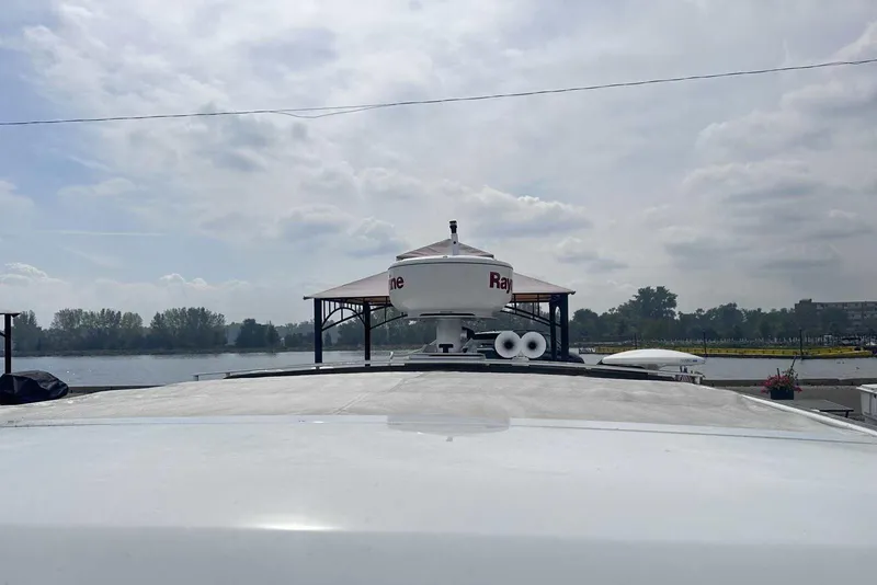 Slide: The Image of 2022 Formula 350 Crossover Bowrider I/O on a calm river under cloudy skies. - 37
