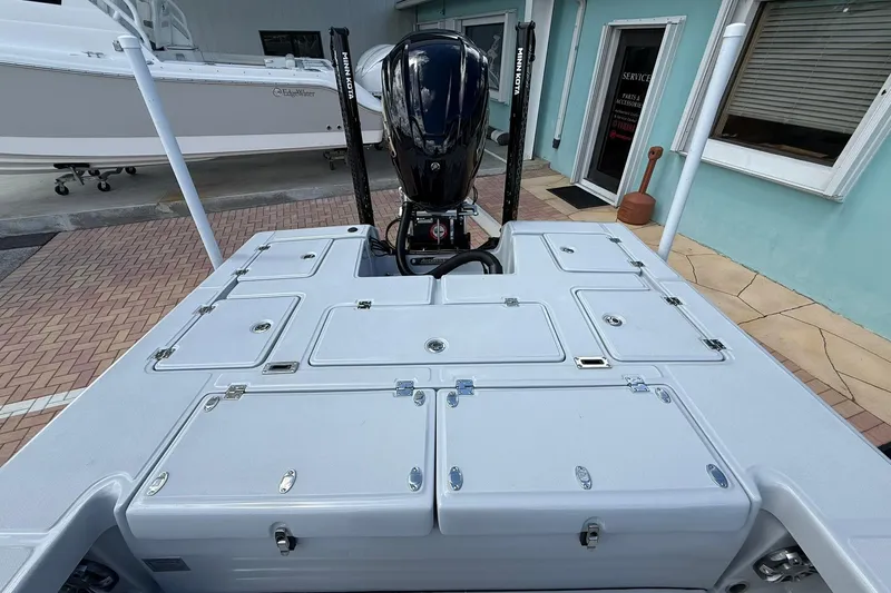 Slide: The Image of 2026 Action Craft 20 Flatsmaster boat with storage compartments and outboard motor. - 13