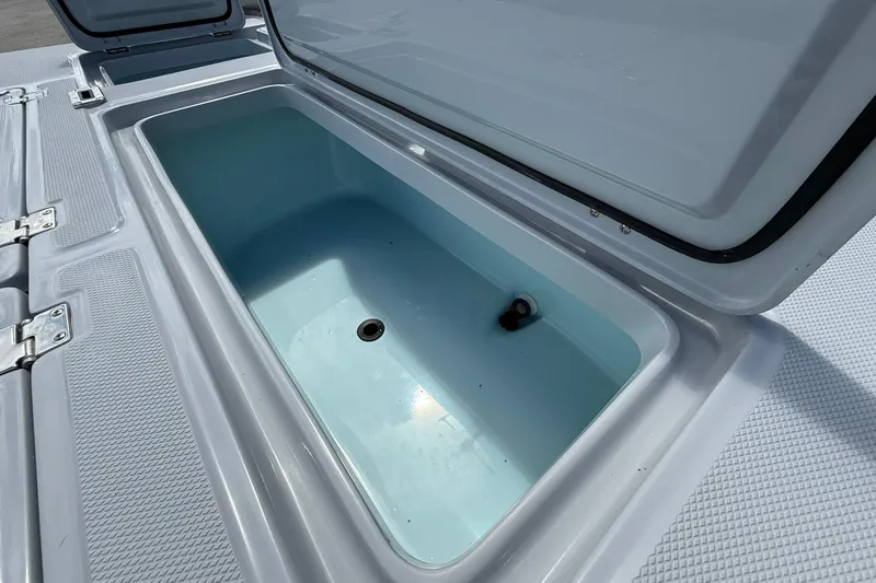 Slide: The Image of Open storage compartment on 2026 Action Craft 20 Flatsmaster boat. - 17