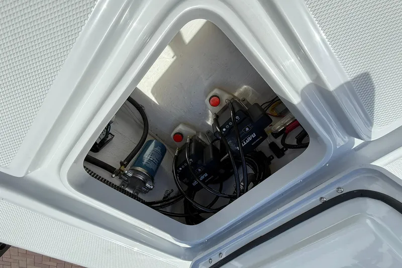 Slide: The Image of Action Craft 20 Flatsmaster 2026 boat compartment with wiring and components. - 18