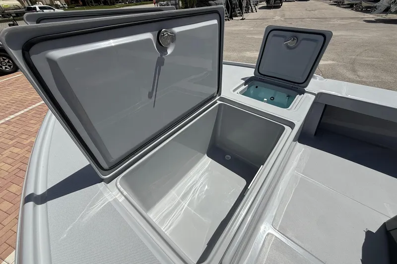 Slide: The Image of 2026 Action Craft 20 Flatsmaster boat storage compartments open on deck. - 26