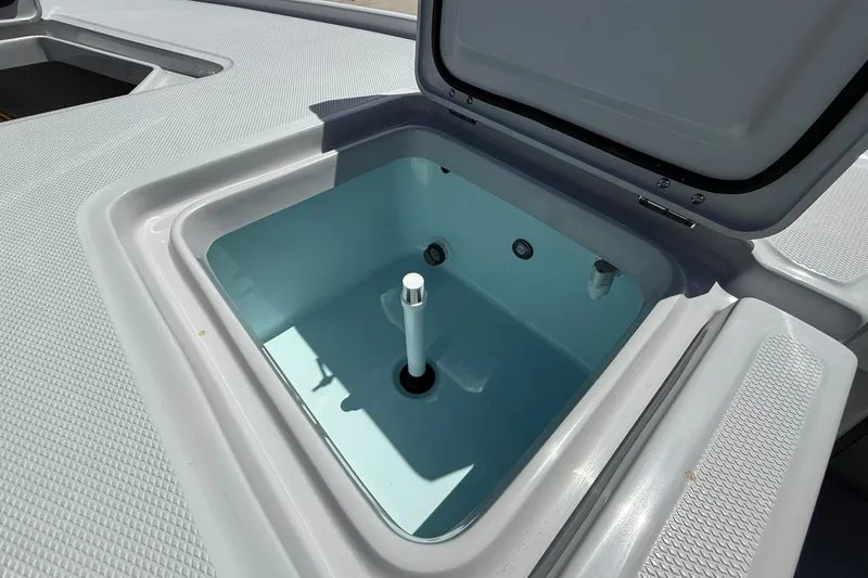 Slide: The Image of Open storage compartment on 2026 Action Craft 20 Flatsmaster boat deck. - 27