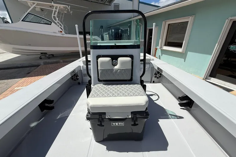 Slide: The Image of 2026 Action Craft 20 Flatsmaster boat interior with cushioned seating and Yeti cooler. - 30
