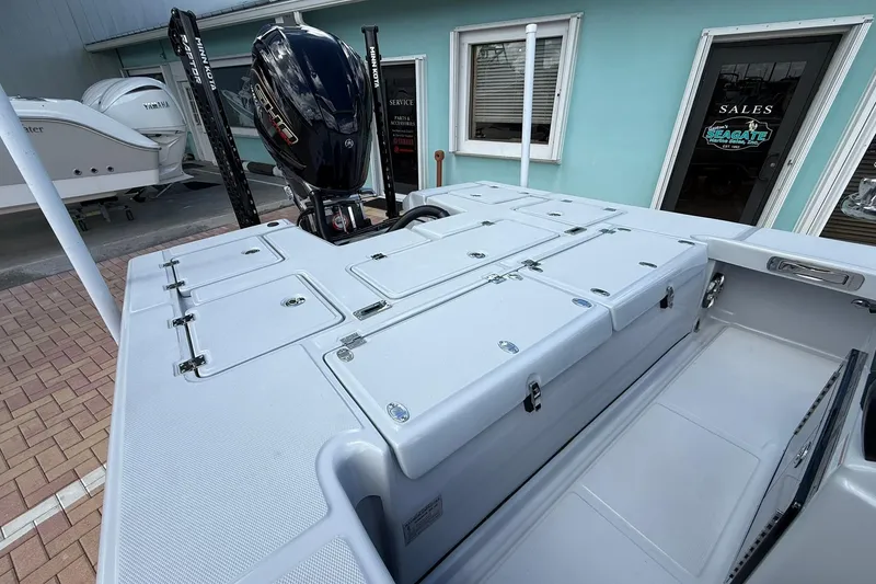 Slide: The Image of 2026 Action Craft 20 FLATSMASTER boat with storage compartments and outboard motor, displayed at dealership. - 12