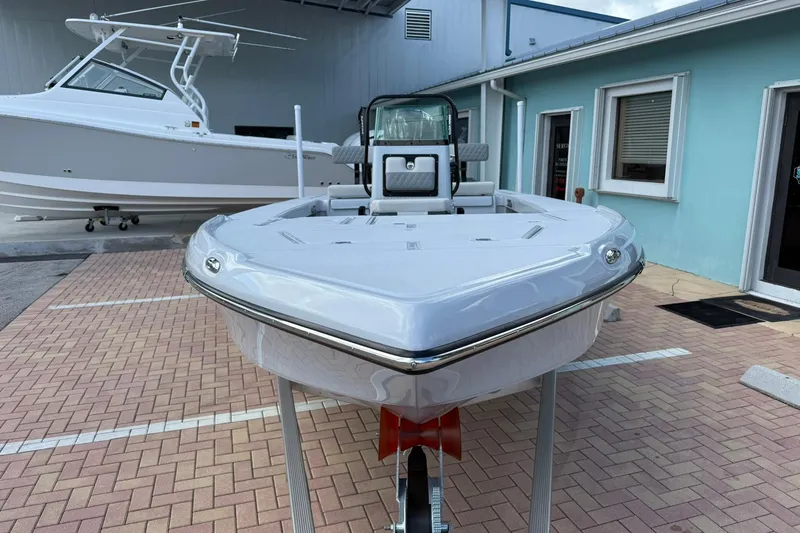 Slide: The Image of 2026 Action Craft 20 FLATSMASTER boat on display, parked on a brick surface. - 2