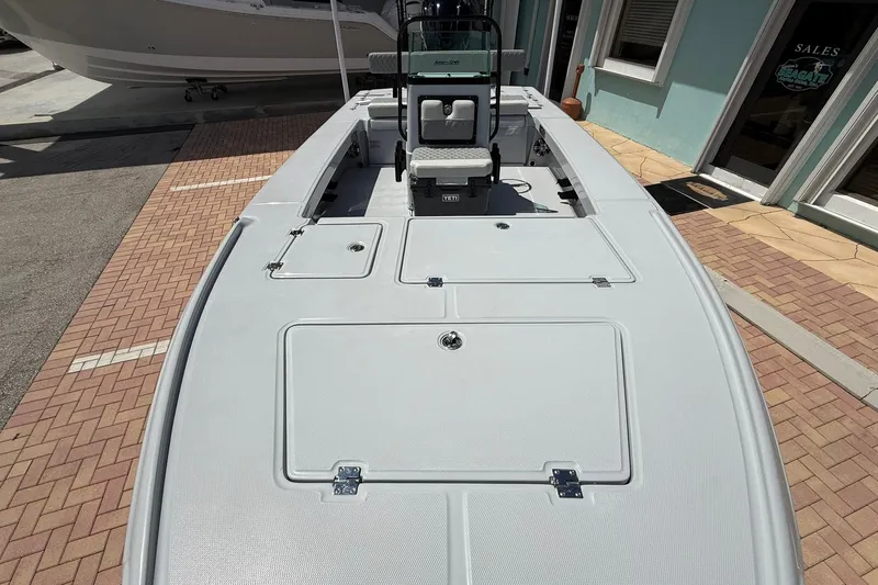 Slide: The Image of 2026 Action Craft 20 Flatsmaster boat, spacious deck, sleek design, parked near sales office. - 29