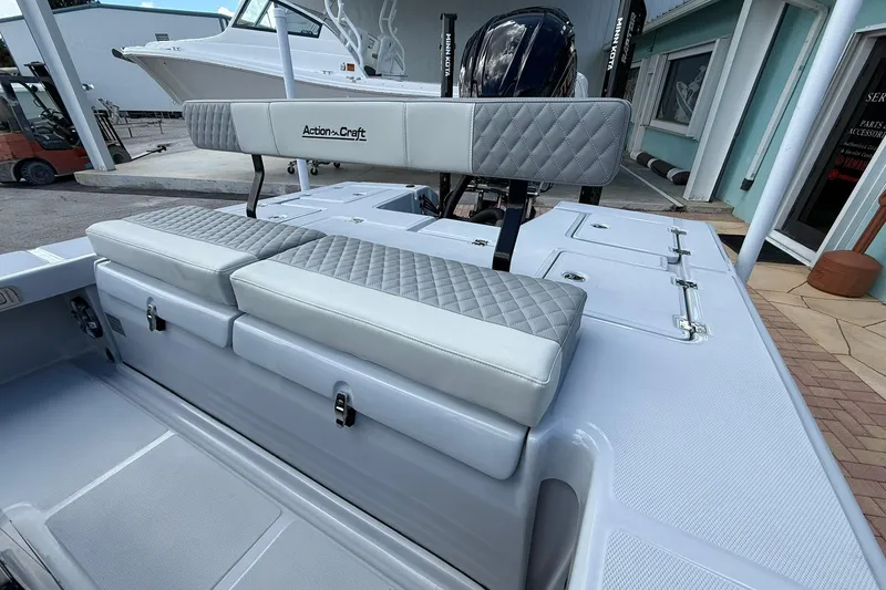 Slide: The Image of 2026 Action Craft 20 Flatsmaster boat with cushioned seating and storage compartments. - 8