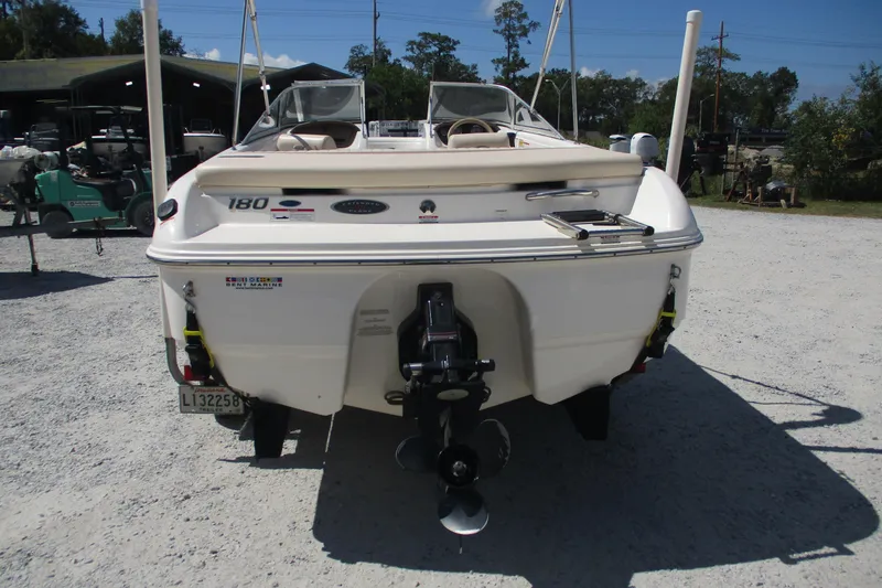 Slide: The Image of 2007 CHAPARALL 180 boat, rear view, parked on gravel, showcasing outboard motor. - 3
