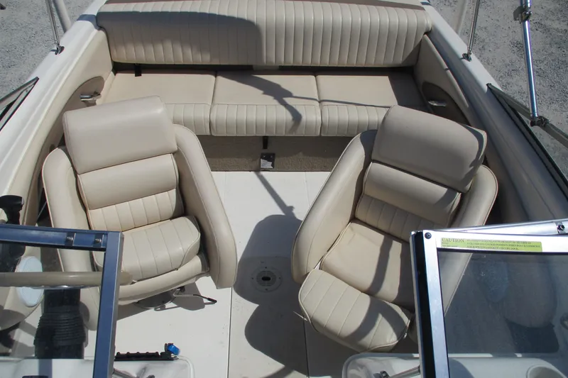 Slide: The Image of Interior of 2007 CHAPARALL 180 boat with beige seating and steering console. - 9