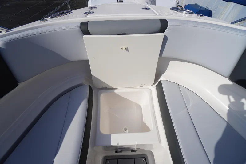 Slide: The Image of 2026 Chaparral 250 OSX boat interior with open storage compartment. - 12