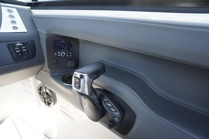 Slide: The Image of Control panel of 2026 Chaparral 250 OSX boat with throttle and switches. - 19
