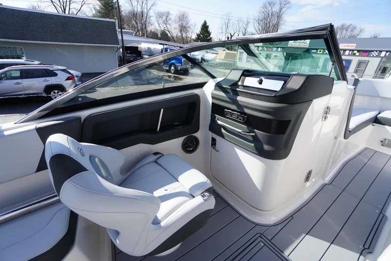 Slide: The Image of Interior view of 2026 Chaparral 250 OSX boat, featuring sleek seating and modern dashboard. - 25