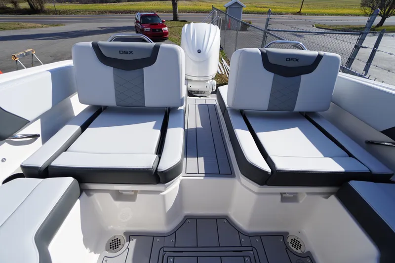 Slide: The Image of 2026 Chaparral 250 OSX boat interior with dual cushioned seats and sleek design. - 33