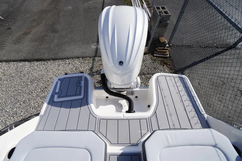 Slide: The Image of 2026 Chaparral 250 OSX boat with sleek deck and powerful outboard motor. - 42