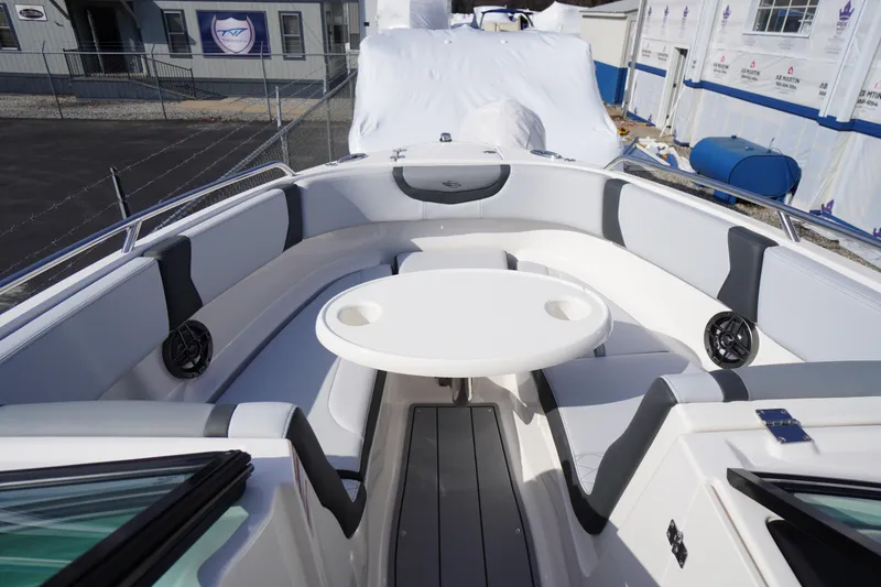 Slide: The Image of 2026 Chaparral 250 OSX boat interior with seating and round table. - 8
