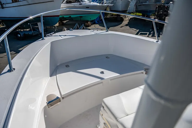 Slide: The Image of 2016 Edgewater 188CC boat interior with white seating and stainless steel railings. - 12