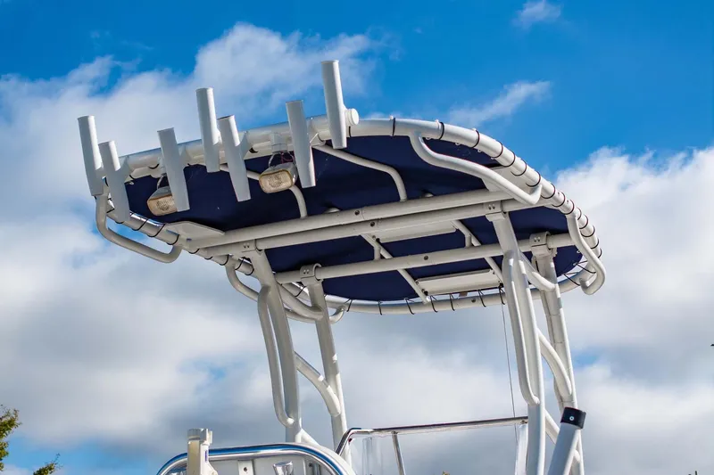 Slide: The Image of 2016 Edgewater 188CC boat T-top against a blue sky with clouds. - 13
