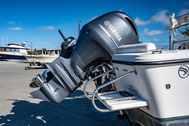 Slide: The Image of 2016 Edgewater 188CC boat with Yamaha outboard motor, docked under clear blue sky. - 14