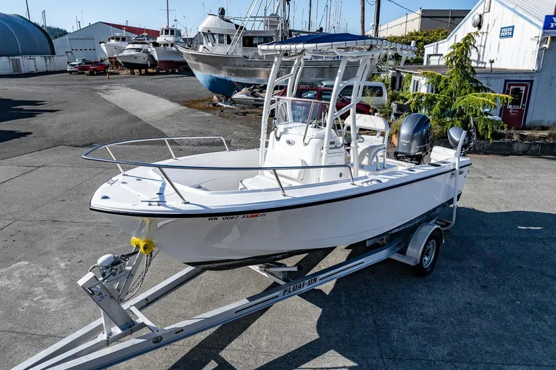 Slide: The Image of 2016 Edgewater 188CC boat on trailer in marina setting, surrounded by other boats. - 3