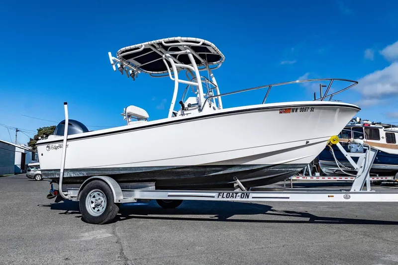 Slide: The Image of 2016 Edgewater 188CC boat on trailer under clear blue sky. - 4