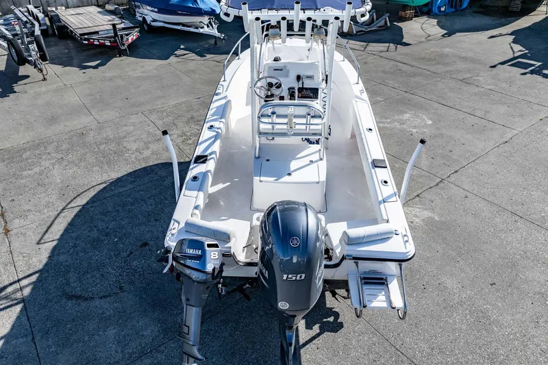 Slide: The Image of 2016 Edgewater 188CC boat with Yamaha outboard motor, parked on concrete surface. - 6