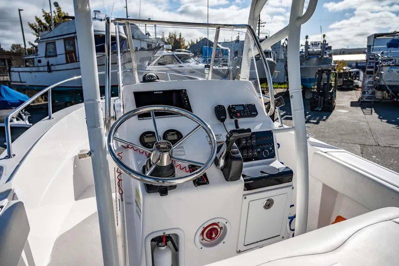 Slide: The Image of 2016 Edgewater 188CC boat console with steering wheel and navigation controls. - 7