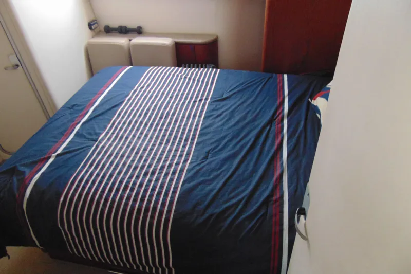 Slide: The Image of Interior cabin of 1999 Maxum 4100 SCA with striped bedding. - 11