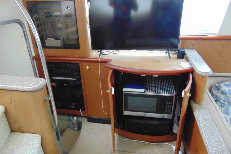 Slide: The Image of Interior of 1999 Maxum 4100 SCA yacht with TV, microwave, and control panel. - 12