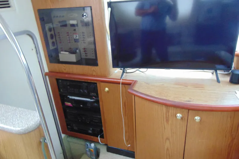 Slide: The Image of 1999 Maxum 4100 SCA yacht interior with TV and control panel. - 13