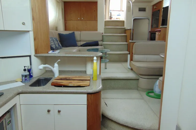 Slide: The Image of Interior of 1999 Maxum 4100 SCA yacht with kitchen and seating area. - 14