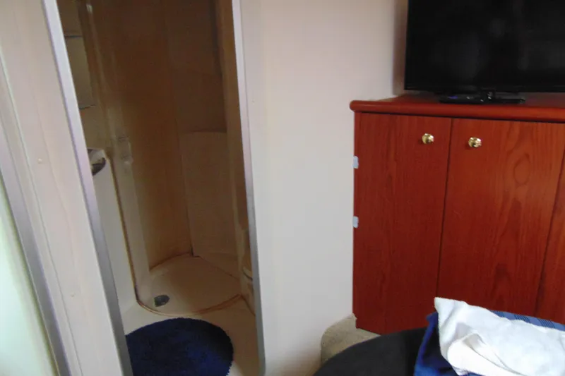 Slide: The Image of Interior of 1999 Maxum 4100 SCA yacht with shower and wooden cabinet. - 15