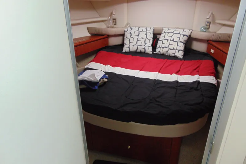 Slide: The Image of Cozy bedroom in 1999 Maxum 4100 SCA yacht with colorful bedding and patterned pillows. - 16