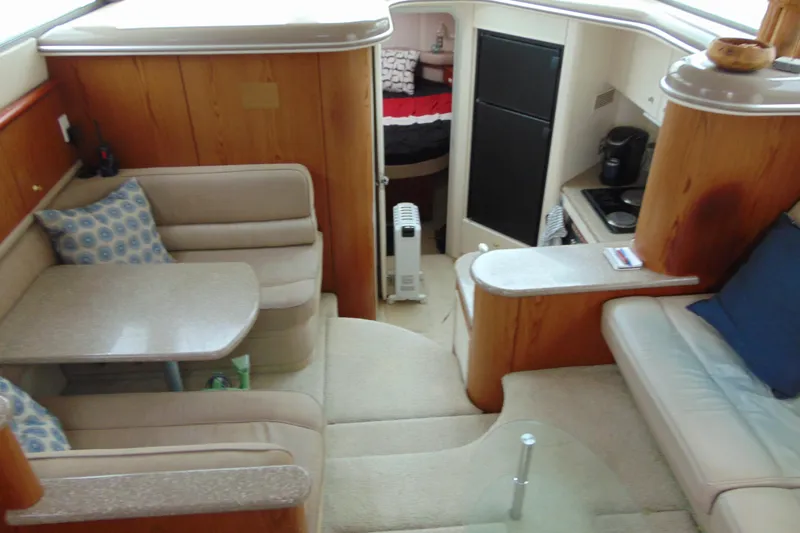 Slide: The Image of Interior of 1999 Maxum 4100 SCA yacht with cozy seating and kitchenette. - 18