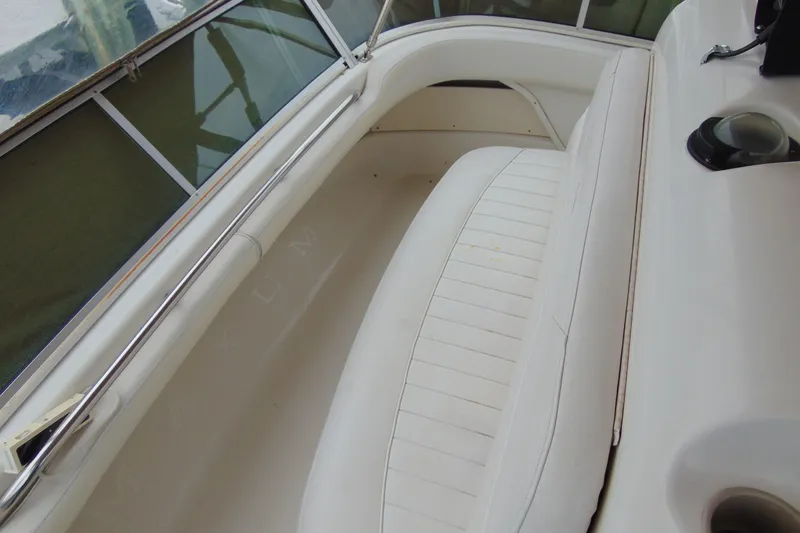 Slide: The Image of 1999 Maxum 4100 SCA boat interior with white seating and chrome railing. - 21