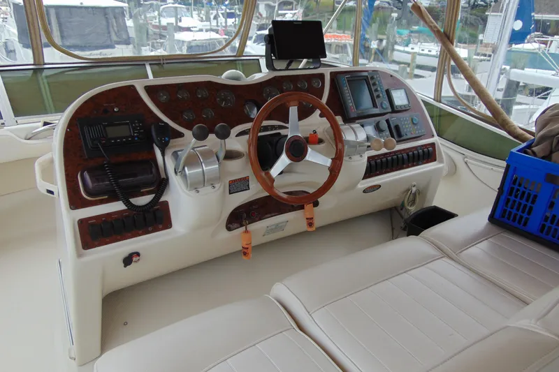 Slide: The Image of 1999 Maxum 4100 SCA yacht helm with wood accents and navigation equipment. - 22