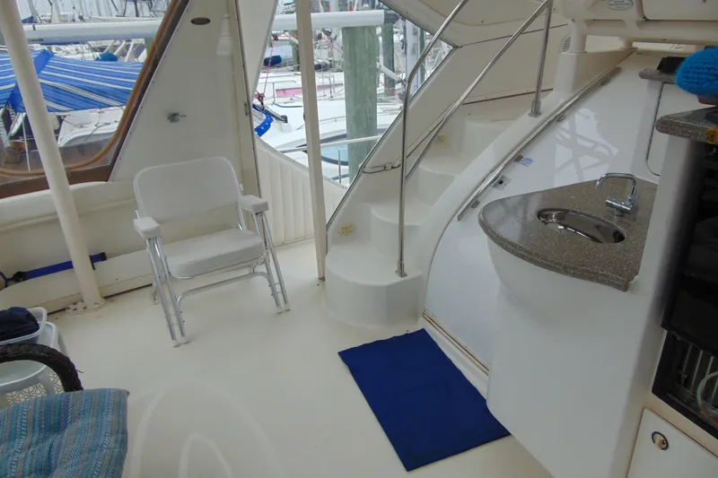 Slide: The Image of 1999 Maxum 4100 SCA yacht interior with stairs, chair, and compact sink area. - 23