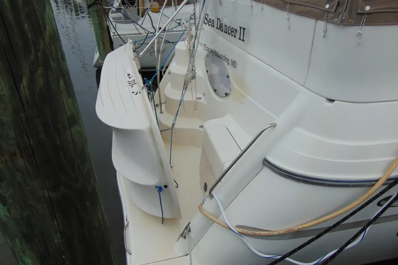 Slide: The Image of 1999 Maxum 4100 SCA yacht docked, featuring "Sea Dancer II" name and mooring lines. - 3