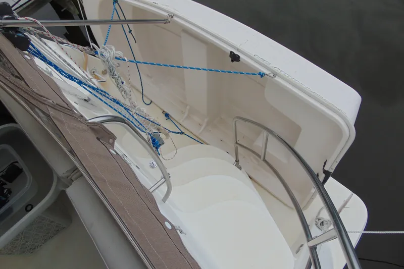 Slide: The Image of 1999 Maxum 4100 SCA yacht deck with open storage compartment and ropes. - 6