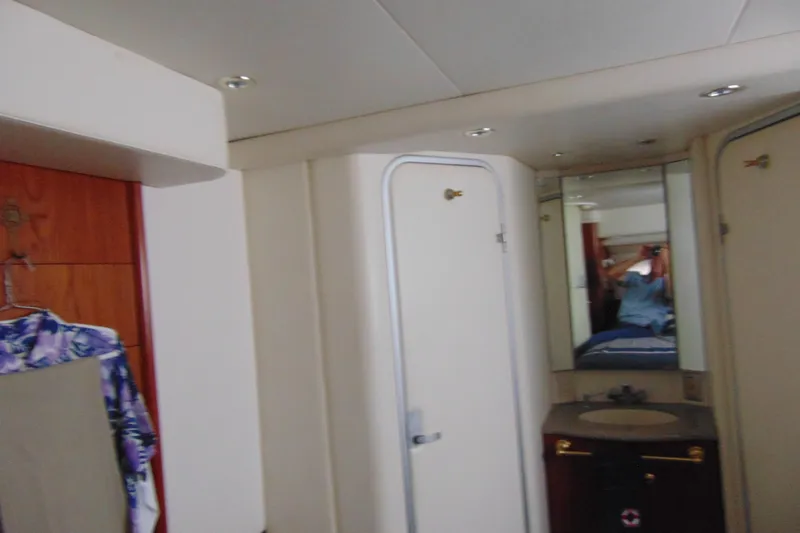 Slide: The Image of Interior of 1999 Maxum 4100 SCA yacht, featuring a bathroom and mirror. - 7