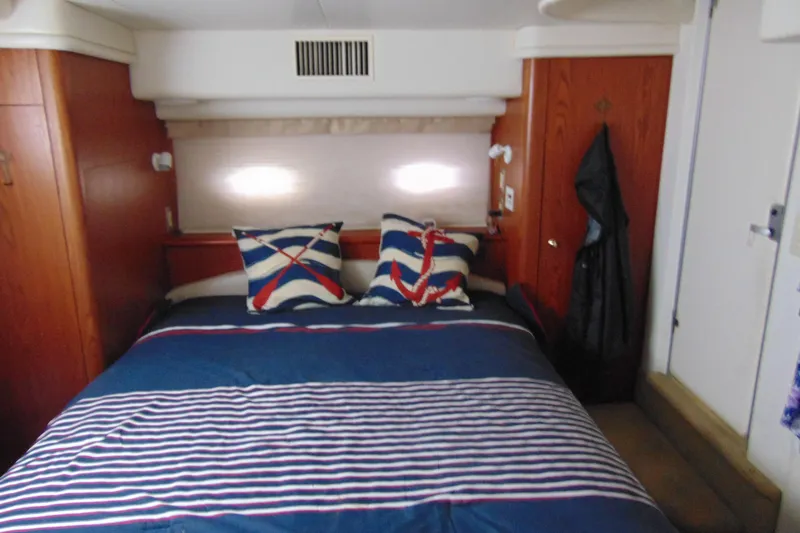 Slide: The Image of Cozy bedroom in 1999 Maxum 4100 SCA yacht with nautical-themed decor. - 8